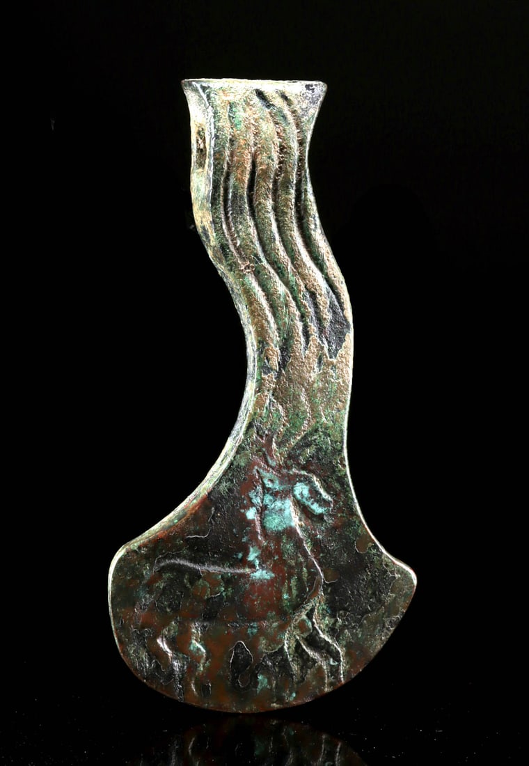Bronze Age Koban Culture Votive Axe w/ Stag Motifs: Central Asia, Russia / Georgia, North Caucasus region, Koban culture, Late Bronze to Iron Age, ca. 1200 to 350 BCE. A decorated bronze axe head featuring a sinuous neck adorned with etched grooves and