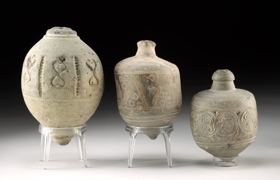 Three Byzantine Pottery Sphero-Conical Vessels: Eastern Mediterranean, Byzantine Empire, ca. 10th to 13th century CE. A trio of stout, enigmatic sphero-conical vessels rises from the Byzantine twilight, each one shaped for the hand and carved with