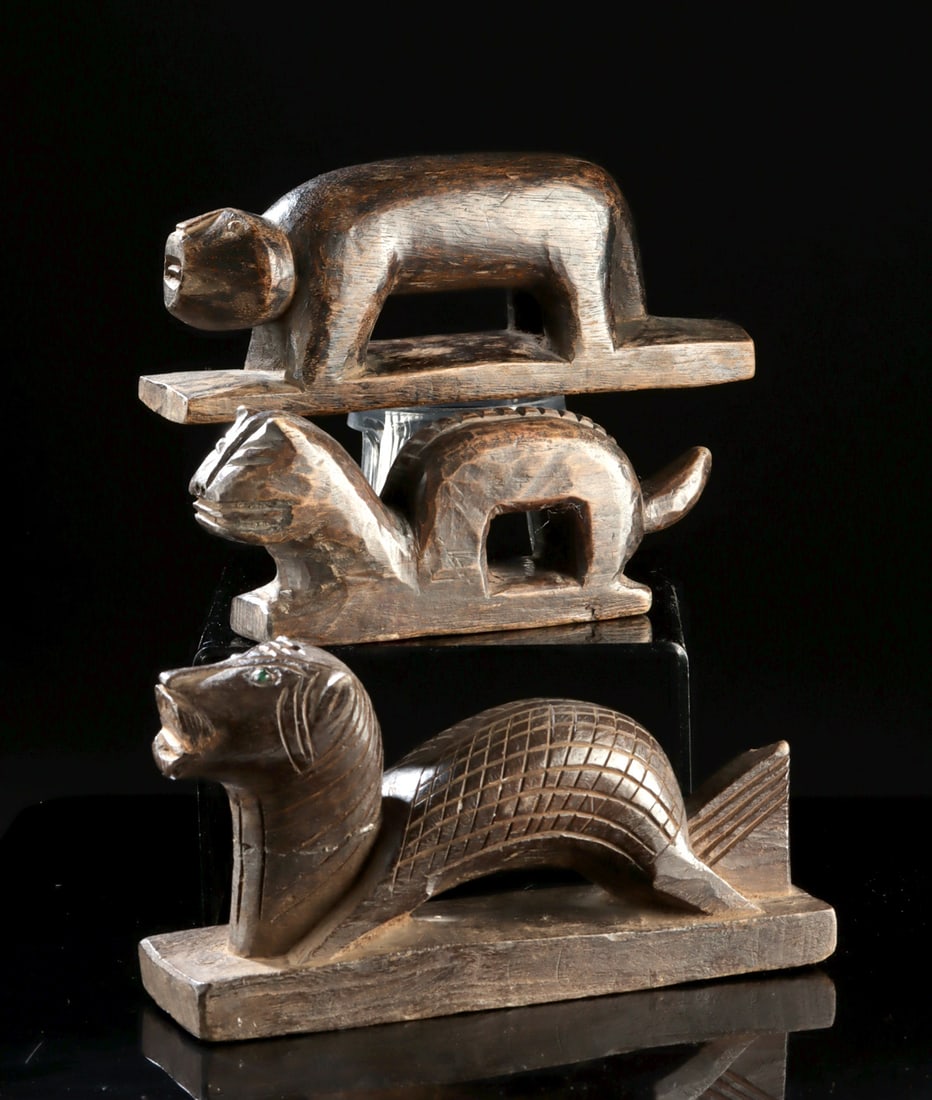 Three Yao Culture Wood Panhu Dragon-Dog Figures: Southeast Asia, Southern China & Northern Vietnam, Yao culture, ca. 19th to early 20th century CE. A trio of carved palm wood animal figures depicting sinuous dragon-dogs known as Panhu, each rendered