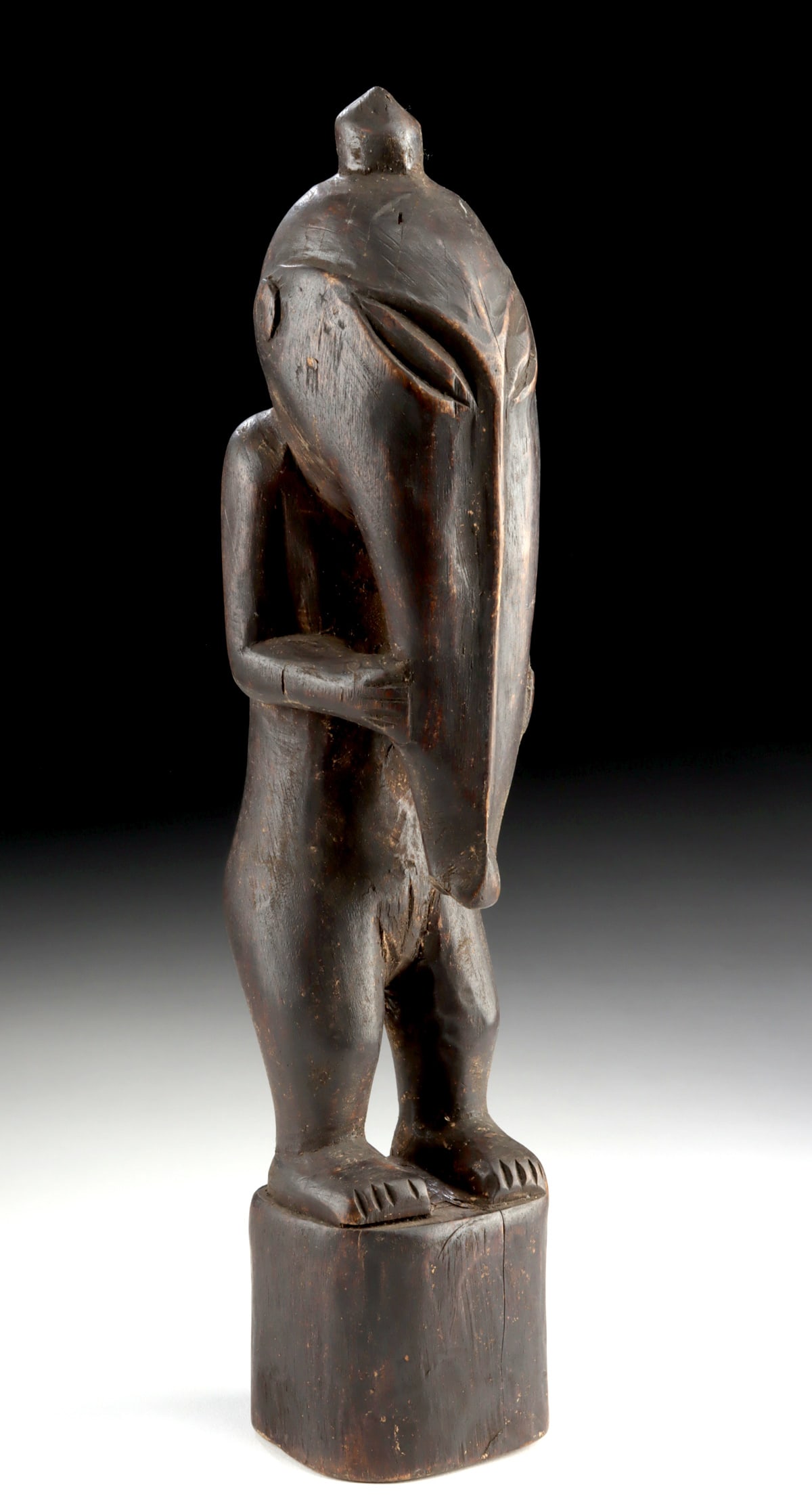 Papua New Guinea Sepik Wood Ancestor Figure: Oceania, Papua New Guinea, East Sepik region, ca. early 20th century CE. A carved wooden ancestor figure characterized by a tall, attenuated stance and a dramatically elongated nose that suggests a ce