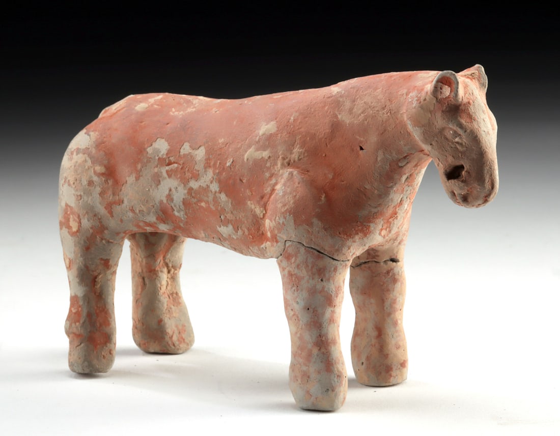 Chinese Han Dynasty Pottery Horse - Mingqi Figure: East Asia, China, Han Dynasty, ca. 206 BCE to 220 CE. A quiet, earth-toned companion from the afterlife, this Han Dynasty pottery horse stands with a gentle, almost meditative stillness, its lowered h