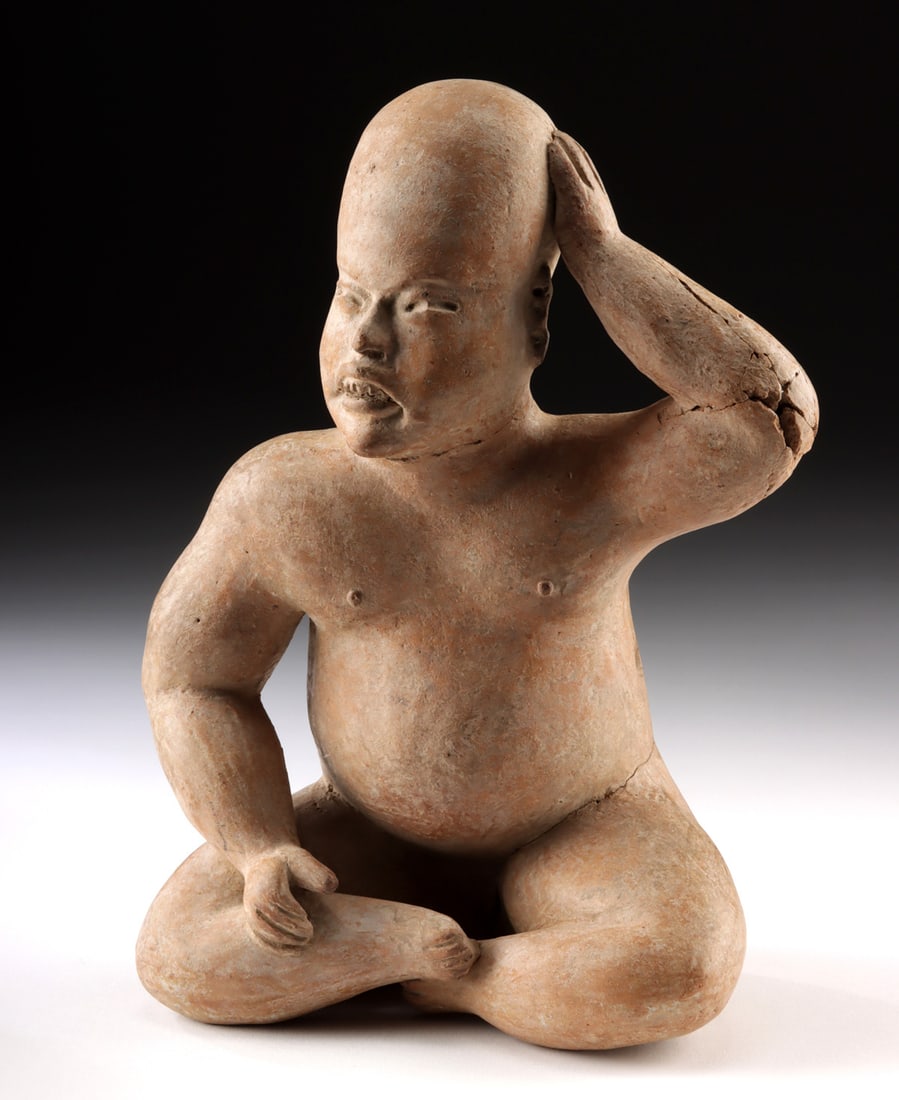 Olmec Pottery Seated Baby w/ Elongated Cranium, TL'd: Pre-Columbian, Gulf Coast Mexico, Olmec culture, ca. 1200 to 400 BCE. A profoundly expressive and exceptionally rare Olmec pottery figure, this seated baby commands attention through both its sculptur