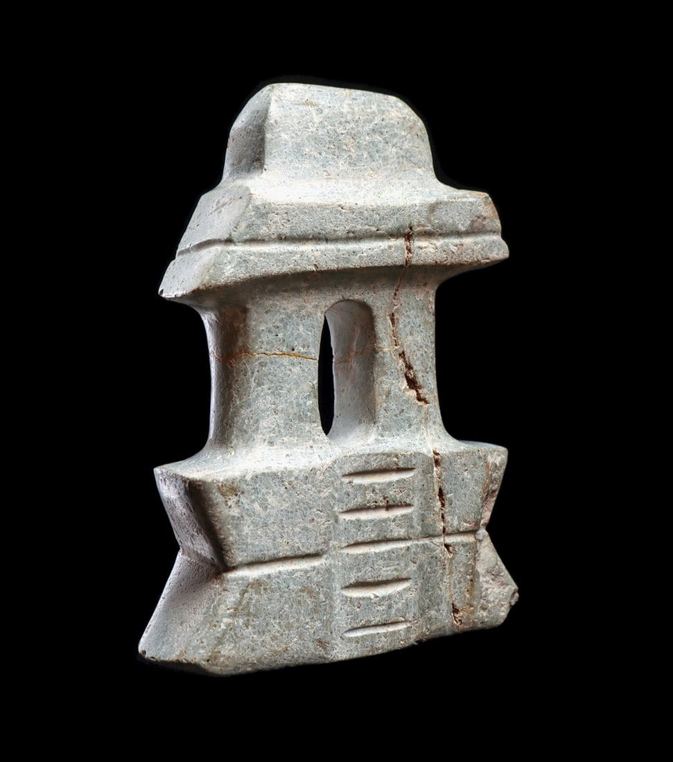 Mezcala Stone Temple: Carved gray-green serpentine stone double column votive temple, having a high corset form platform with center stairs, capped and banded lintel. Overall creamy surface patina. A very minor lower corne