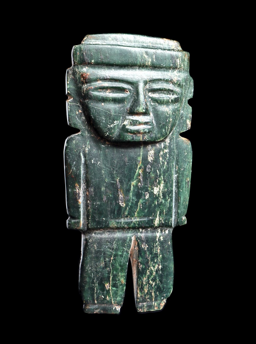 Teotihuacan Serpentine Standing Figure: Carved deep green variegated serpentine slab type standing figure with arms held tightly to his sides. Well carved relief facial features, with recessed narrow eyes and parted lips. wearing a wide hea