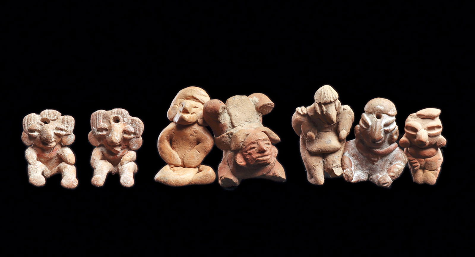 Pre-Classic Miniature Figures (7): Group of seven solid pottery miniature figures including a Michoacan matching pair, having fancy hairdos and each with a suspension hole in the center, resting their hands on their raised knees. Both