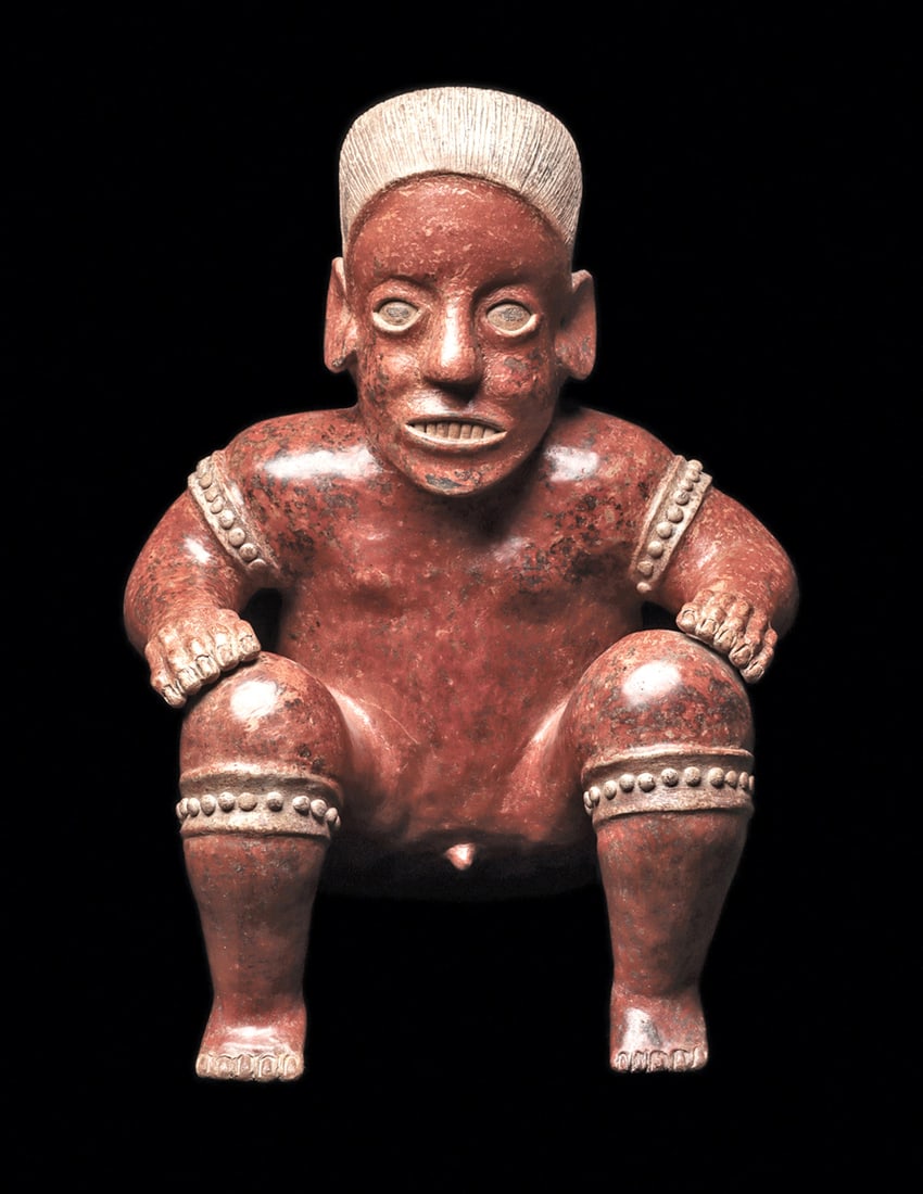 Jalisco Large Redware Wrestler Figure: Large and impressive redware pottery seated wrestler figure, having a finely striated long hairdo with arm and leg ligatures, each having an applied rasised node decoration. Powerful body, with his ha