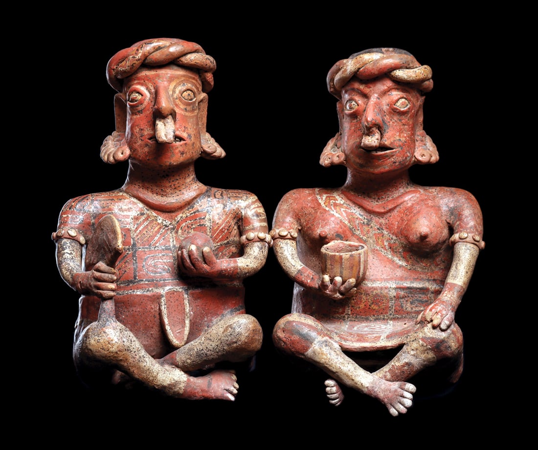 Exceptional Ixlan del Rio Matching Couple: Exceptional pair of orange ware pottery, male and female seated figures. She sits with legs crossed and wears a knee length skirt, decorated arm bands, necklace, fancy ear ornaments, twist type headba