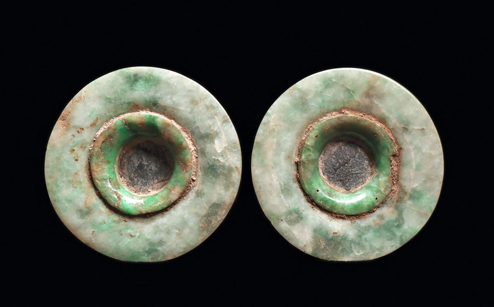 Maya Jade Earspools (2): Matching pair of mottled blue-green and creamy-green jade ear ornaments, of three piece construction consisting of two carved jade ear flares fitted together with a black slate stone fitted disc cente