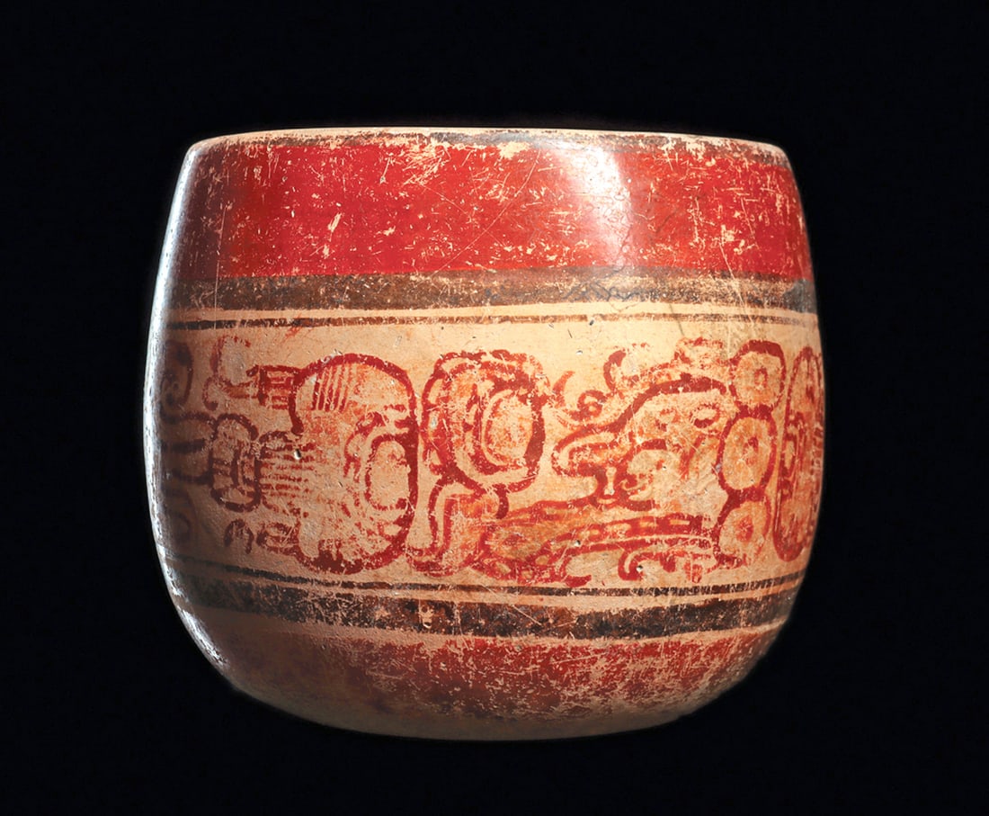 Maya Polychrome Decorated Bowl with Glyphs: Pottery bowl, polychrome decorated with a wide center band with two sets of red-orange painted glyphs. Upper and lower red-orange and black painted bands. Overall general wear to the painted surface.