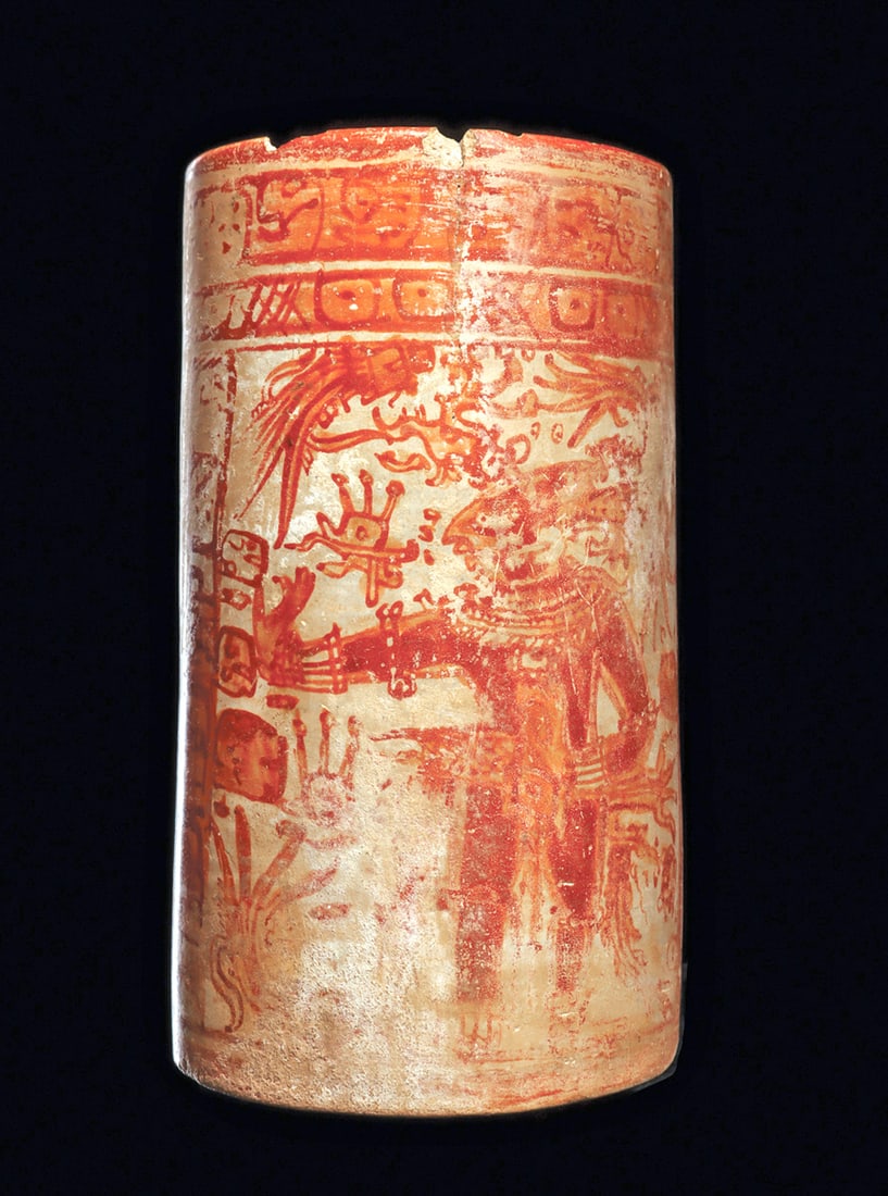 Maya Tall Decorated Cylinder Vase: Large polychrome decorated pottery cylinder vase, rendered in the Holmul style, painted with a twice repeated ornately garbed dignitary, wearing an elaborate feathered headdress. Stylized glyph column