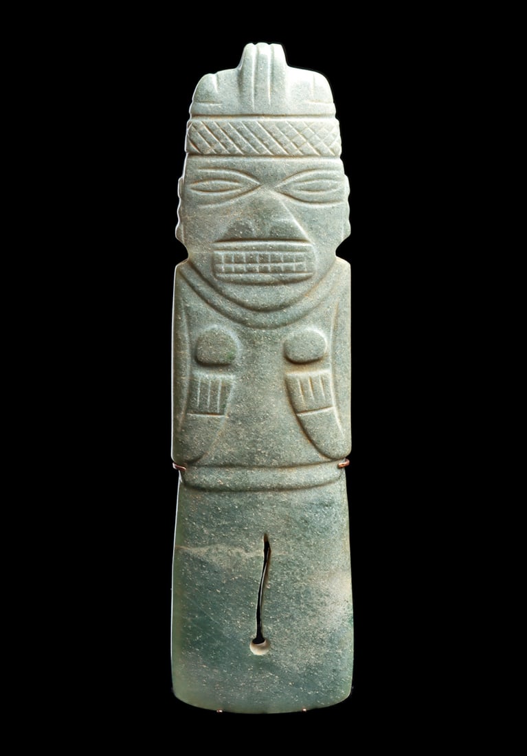Costa Rican Jade Axe God Pendant: Large variegated bluish-green jade large axe god pendant, holding both hands under her round breasts. Low relief carved facial features, with a wide angular nose, wide rectangular toothy mouth and lar