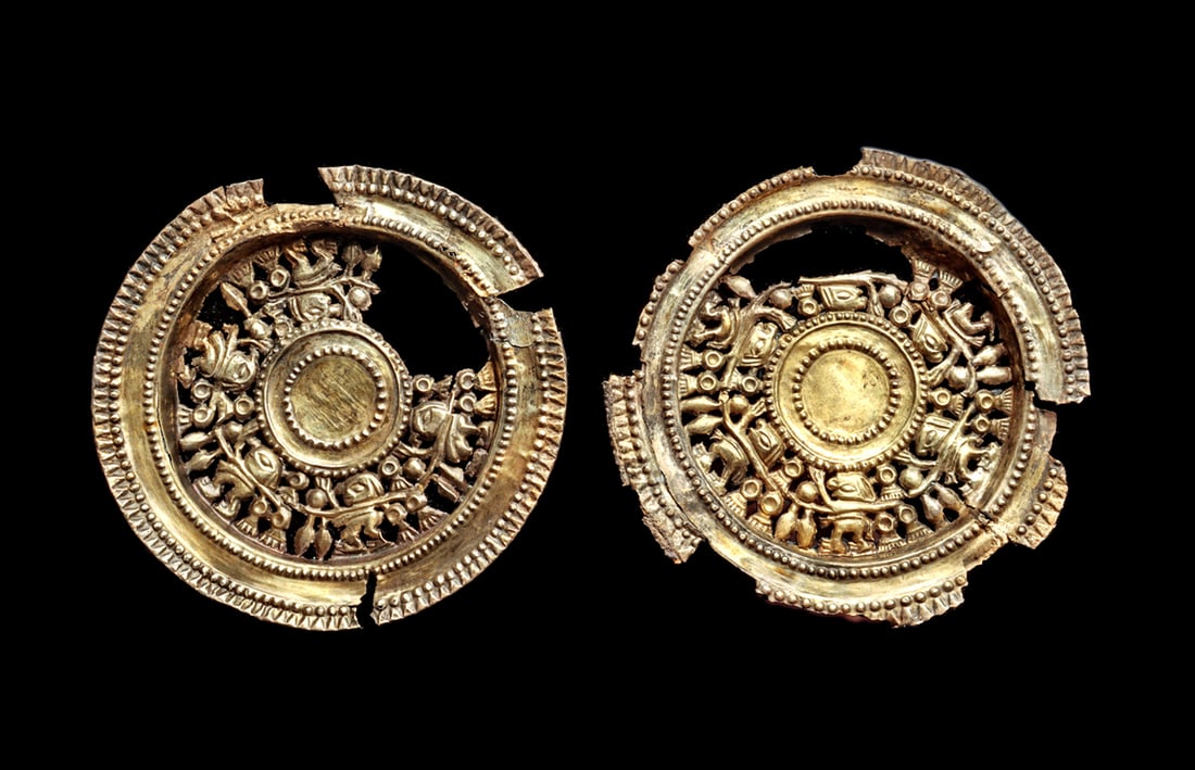 Chimu Pair of Large Gold-Electrum Roundels: large pair of gold-electrum fancy ear ornaments, each depicting a row of anthropomorphic and stylized birds connected to the Life Stream with a center roundel with beaded borders, outer wide rim with