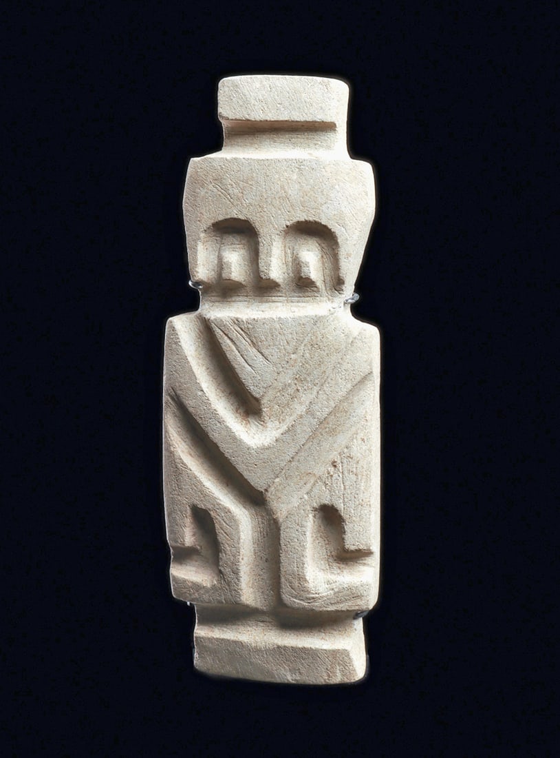 Valdivia Small Limestone Slab Figure: Carved compacted limestone slab avian idol, having deeply carved details. Tapered head with a raised head crest, large tapered beak, arch form squared eyes, and angular curved wings. Scattered areas o