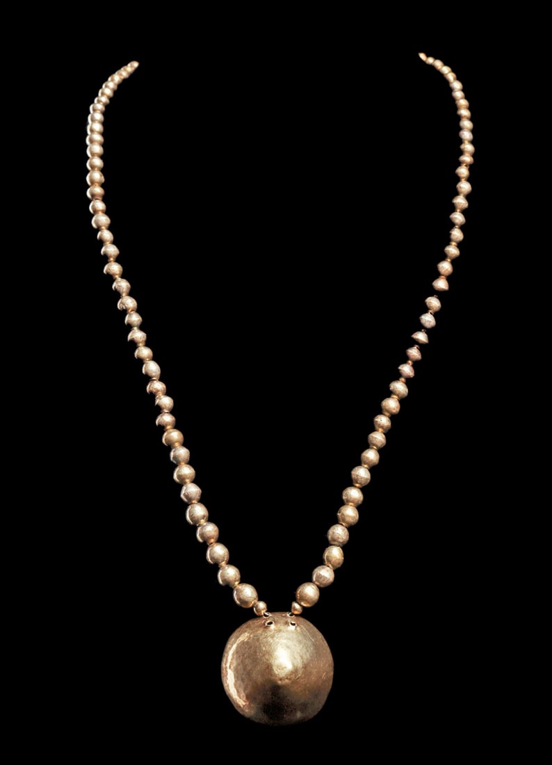 Moche / Chimu Gold Beaded Pendant Necklace: Single strand necklace composed of 96 graduated gold ball beads, with a conical gold pendant in the center. Modern strung with a metal clasp. Sturdy and suitable for wearing. An elegant example. 19"L.