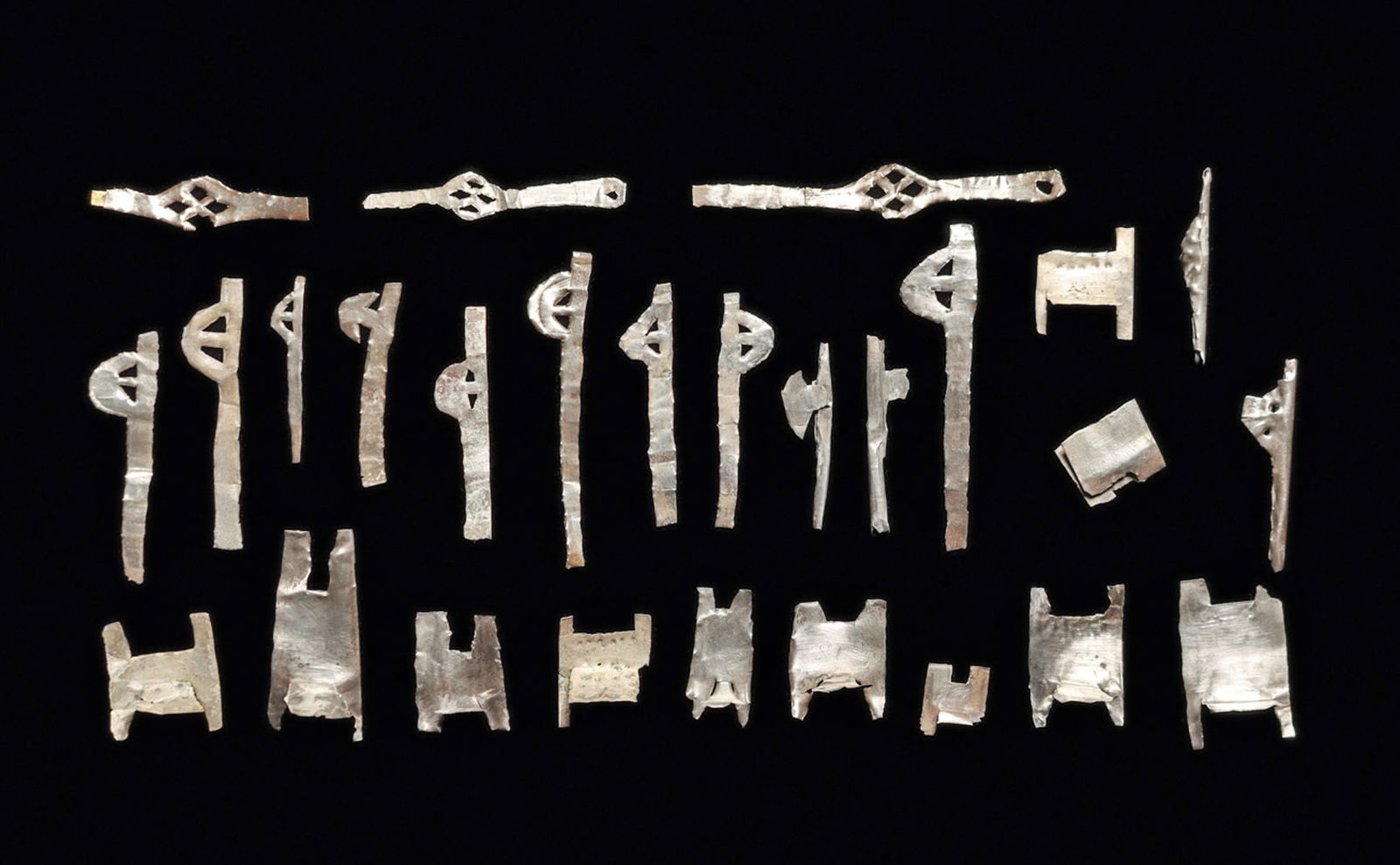 Chimu Sheet Silver Litters & Votive Axes (27): Group of twenty-seven sheet silver votives, including ten simple litters, three have a punched dot decoration. Some with losses or imperfections. Together with twelve votive axes, some have minor impe