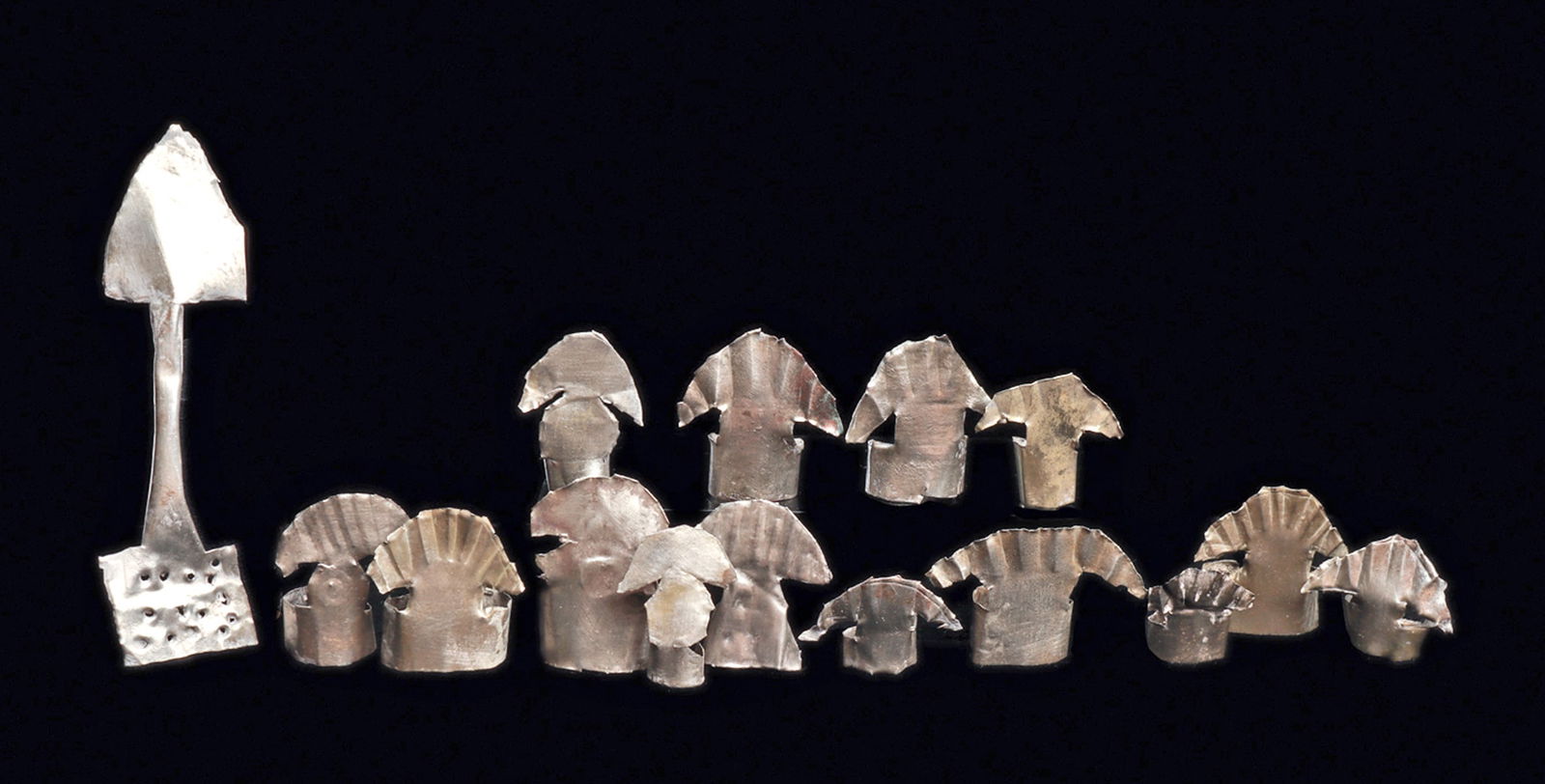 Chimu Silver Miniature Crescent Headdresses & Silver Sh: Group of fourteen similar sheet silver miniature headdresses, all having a crescent form crown, most with a simple stylized feather design, and all have a wide band to be fitted to a votive doll's hea