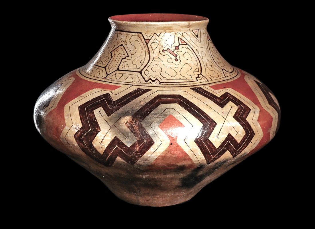 Large Shipibo Decorated Pottery Olla: Large polychrome decorated pottery olla form storage jar. Large saucer shape body, tapered shoulder neck and a flared collar rim. Neck is decorated with a fine line intricate abstract geometric design
