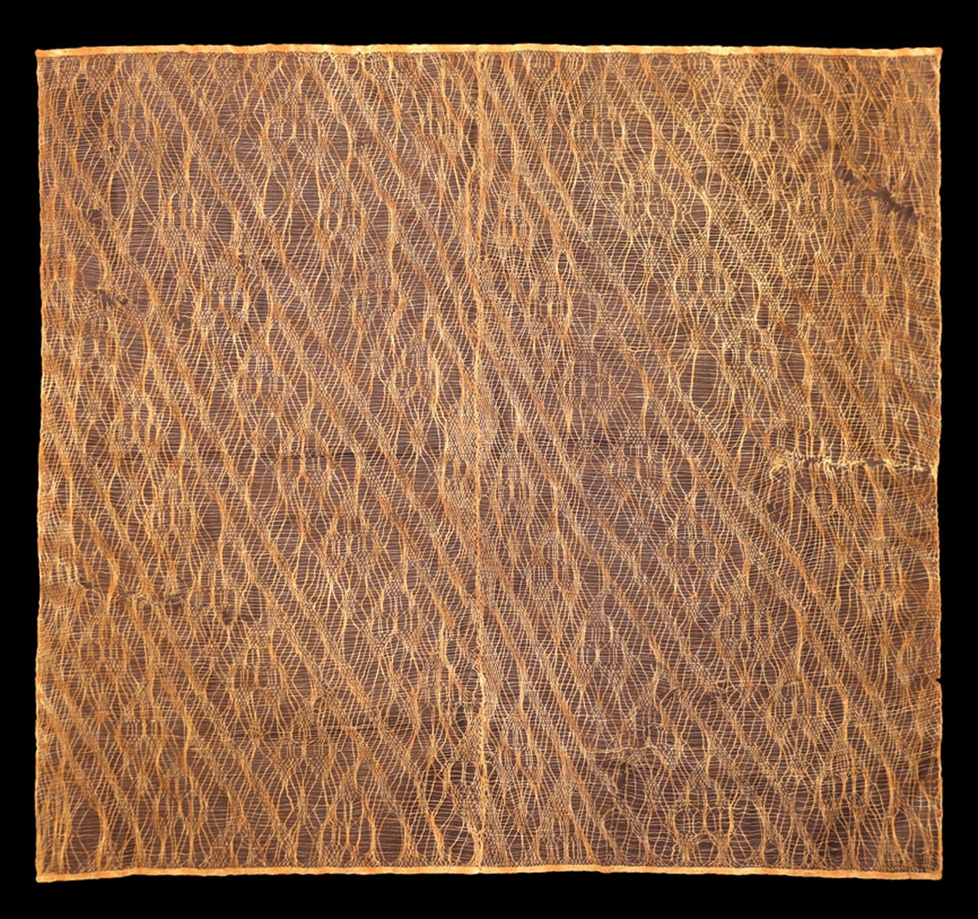 Chancay Gauze Panel: Woven gauze panel having an overall interlocking diamond pattern, each containing a stylized feline head. A few very minor scattered imperfections, and a 4-1/2" sewn edge slit, overall exc. cond. Sewn