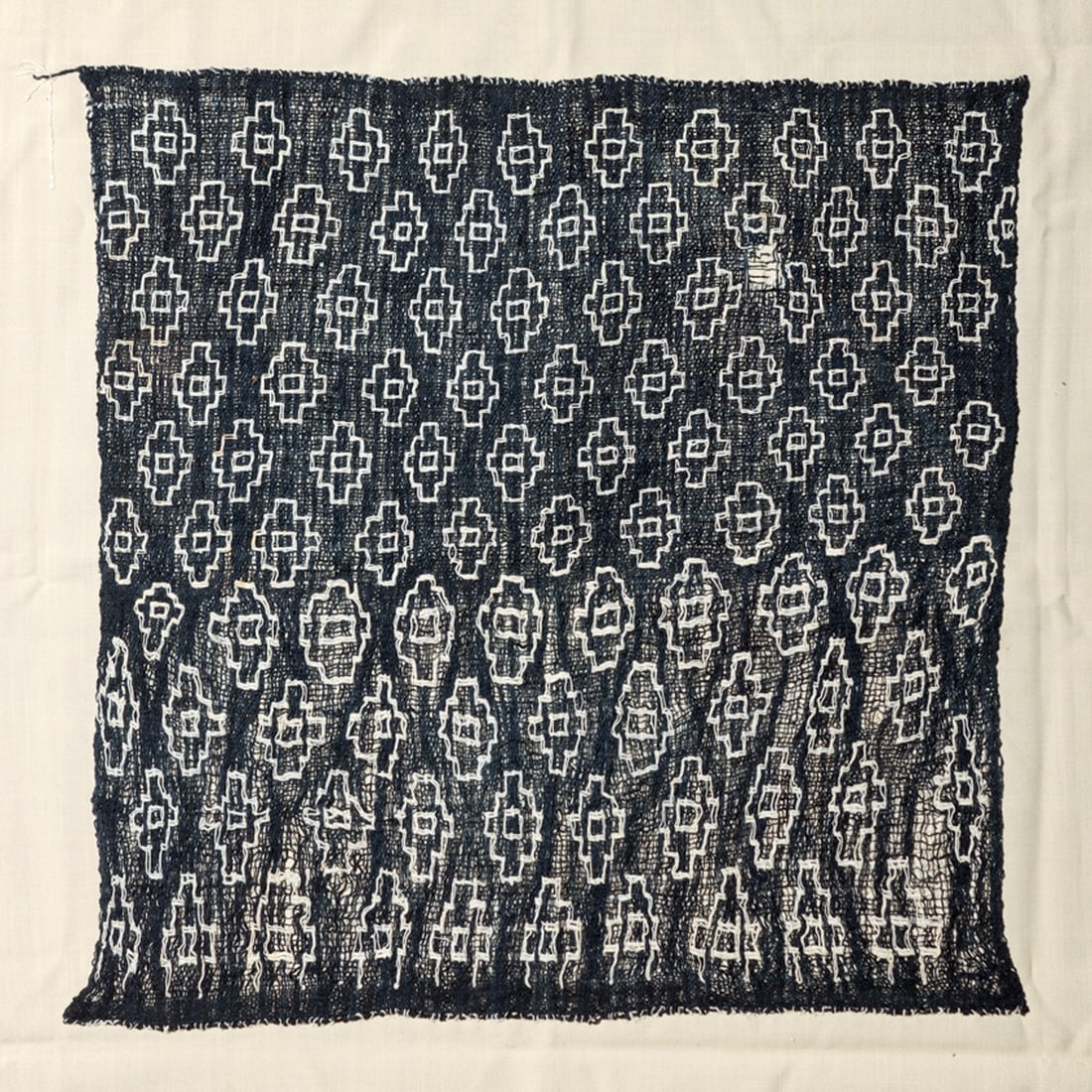 Chancay Blue Gauze with Crosses: Woven deep blue gauze panel decorated with embroidered white stepped cross elements. A minor 1" loss, otherwise overall exc. cond. Sewn to a modern cloth backing. Upper half more tightly woven than th