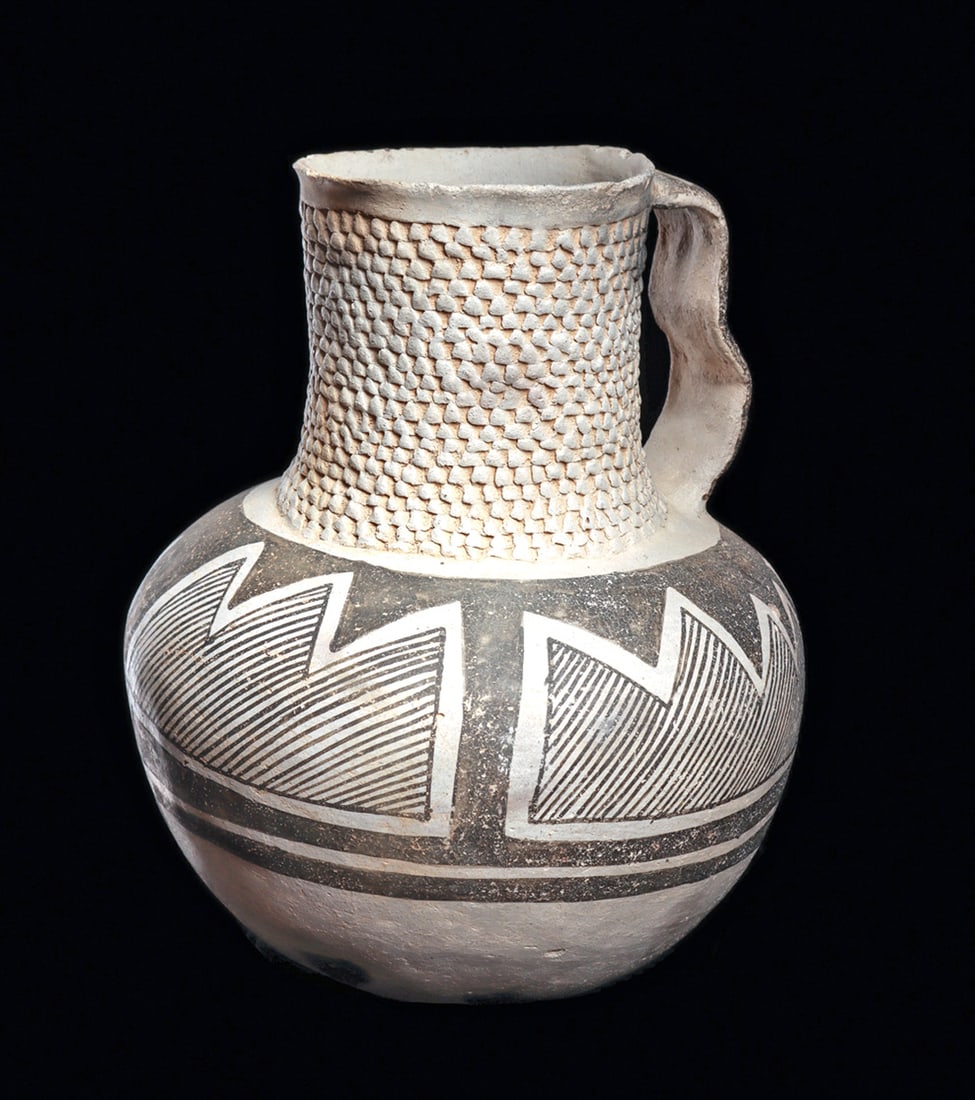 Snow Flake / Anasazi Corrugated Pitcher: Large and fine decorated pitcher, having a beautiful corrugated wide neck and undulated handle with a painted zigzag decoration. Tapered bulbous body decorated with a wide band of fine linear saw-toot