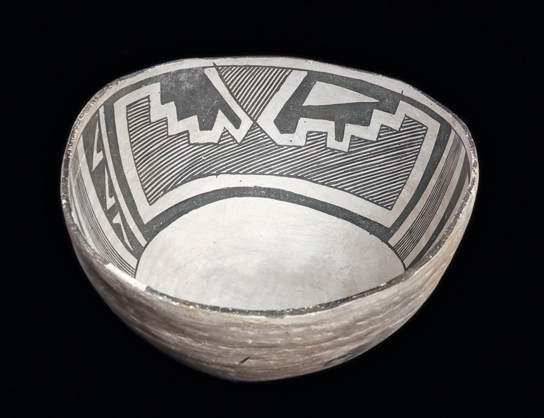 Chaco / Anasazi Black on White Stepped Decorated Bowl: Black on white ovoid pottery bowl decorated on the interior with a wide band of fine linear and stepped designs. Repaired from three original pieces with the extremely fine break lines left visible. C