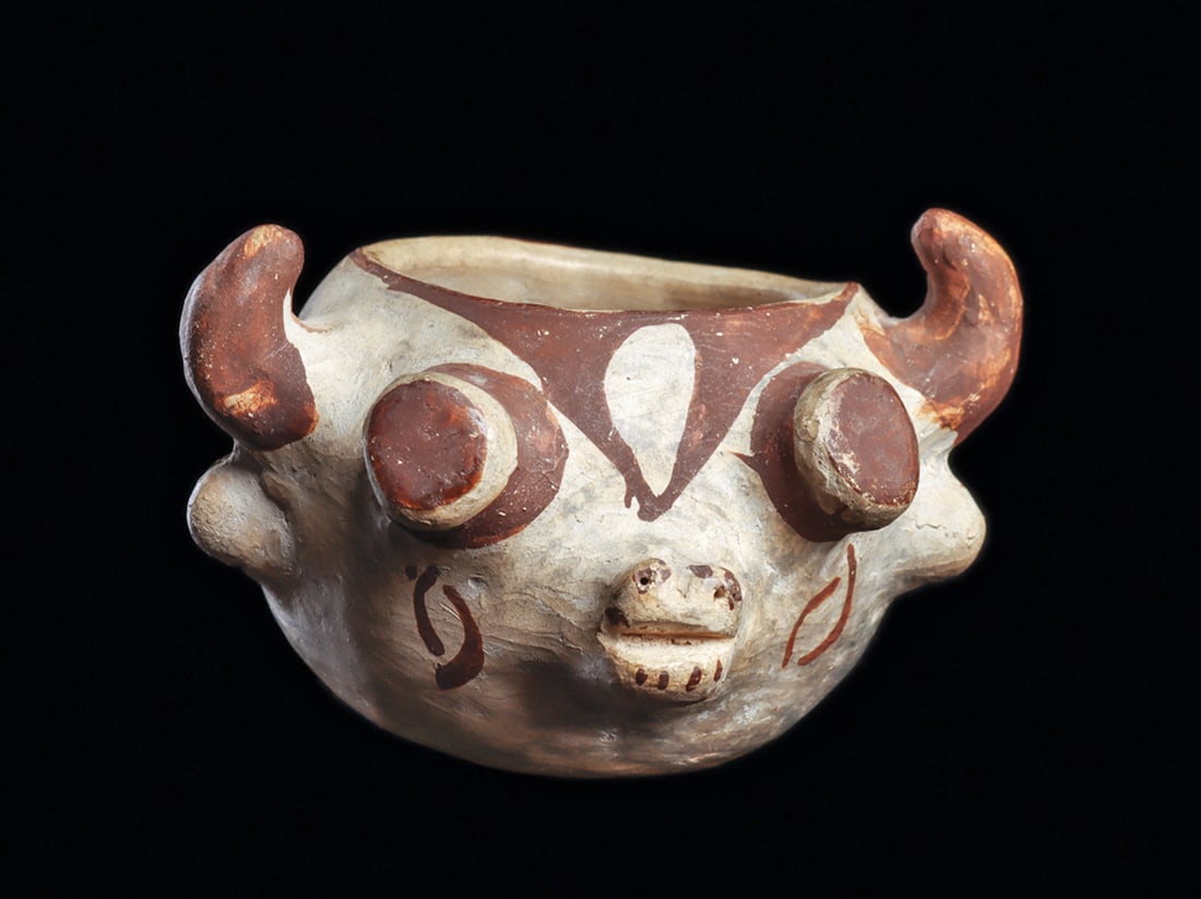 Historic Zuni Kachina Head Pot: Small pottery jar depicting a Kachina head of a bull, with curved horns and projecting cylindrical eyes. An ear of corn is painted on the reverse. Small jars, such as this one, probably had no functio