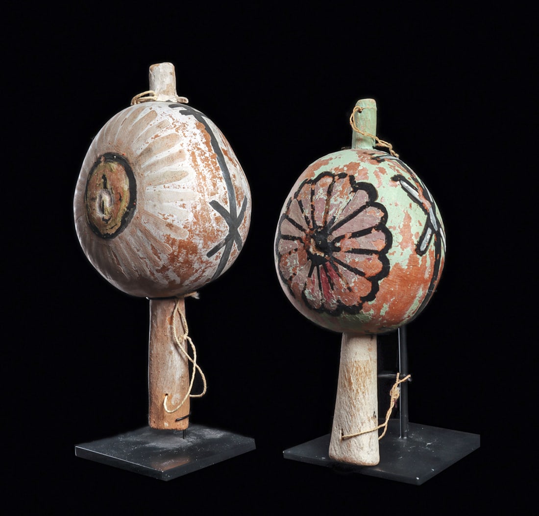 Hopi Ceremonial Dance Rattles (2): two ceremonial gourd dance rattles, each with a painted decoration depicting a large flower on both sides, and have a carved wood handle. Scattered general paint losses, otherwise intact. Each with a