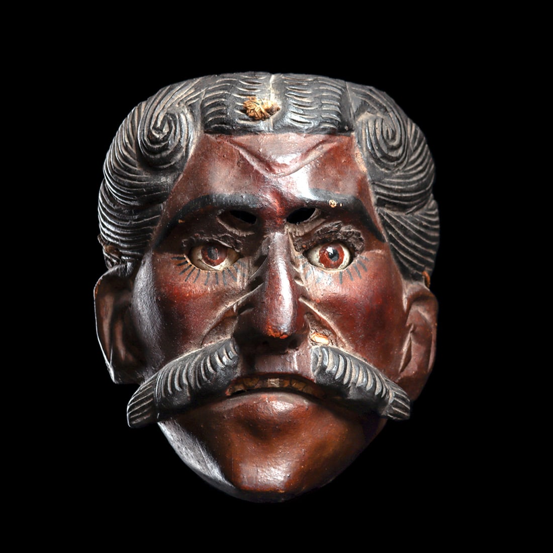 Guatemalan Dance Festival Mask: Good old mask carved for the "dance of the conquest", this portrays a Spaniard having a thick mustache, groomed hairdo with center part, temple curls and a large, prominent nose. Bears inset glass eye