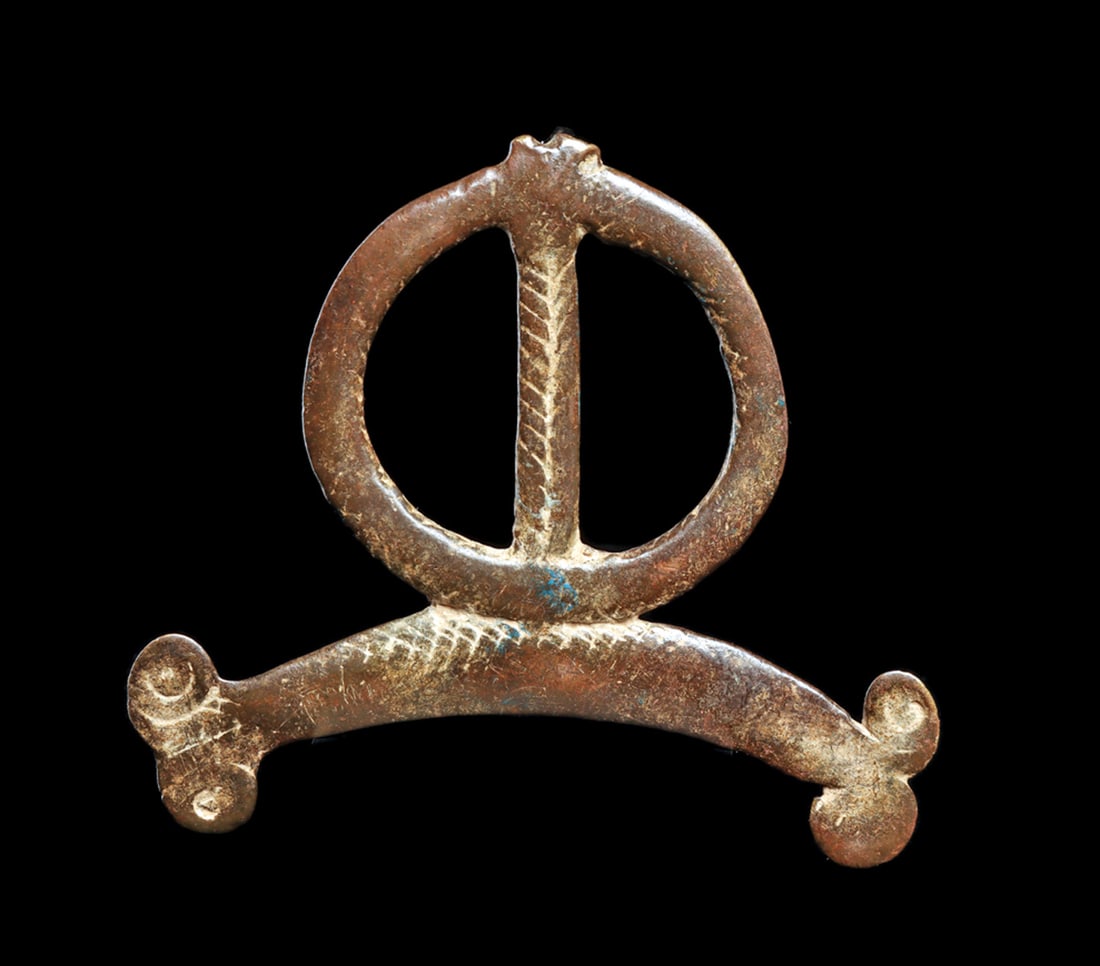 Bronze Amulet: Abstract form, with lightly incised linear patterns along front. Possibly loss above open circle form. Dark smooth patina from long age and handling. 2-3/8"H. Provenance: NYC. collection. Ex. Sotheby