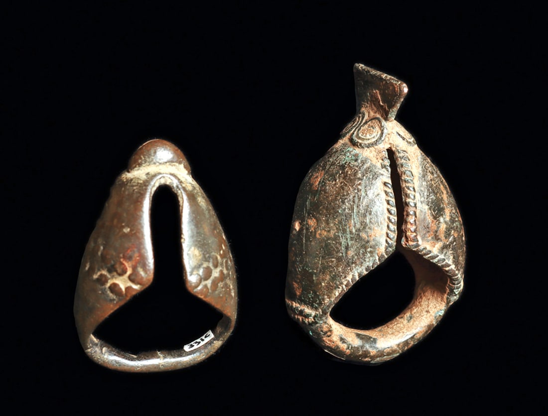 Bobo and Dogon Finger Rings (2): Bobo ring with projecting fin or tail delicately detailed with braided edges, and coil pattern at base of the projecting fin. Dark green-black patina with deposits. Tiny casting hold on side. Together