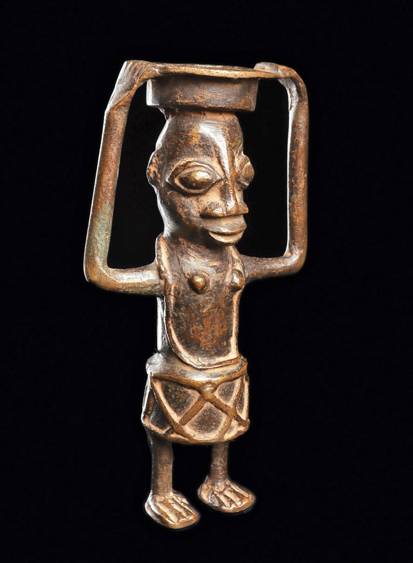 Yoruba Bronze Bowl Bearer: Heavy copper alloy lost wax cast figure of a small female figure standing and carrying a bowl on her head, with long spindly arms supporting the perforated rim of the bowl. Dark brown patina with depo