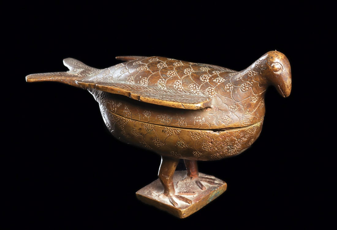 Edo-Bini Bronze Bird Vessel: Fine lost-wax cast brass alloy vessel with fitted lid, in shape of a standing dove with finely engraved imbricated pattern on body and wings. On hollow square integral base. Yellow brown patina, small