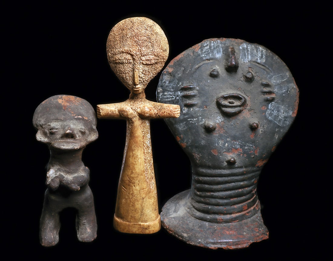 Group of Ghana Works (3): Impressive large Akan memorial head modeled of terracotta, with relief face and scarification, and painted lines at edges in white pigment on disc shaped head. Supported by grooved neck rising from fl
