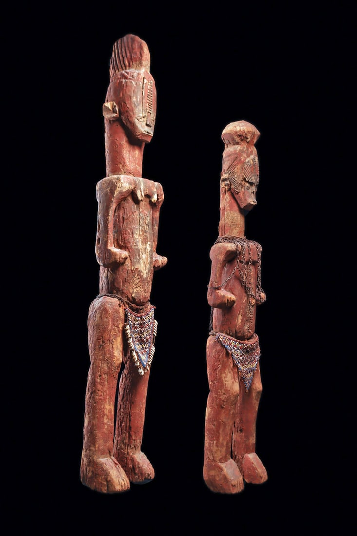 Ibo Alusi Ancestor Figures: Sacred female and youth figures from the southern Igbo region, carved in the distinct geometric angular style of the area, with elaborate tall sagittal crest and domed hairdo. They are probably from