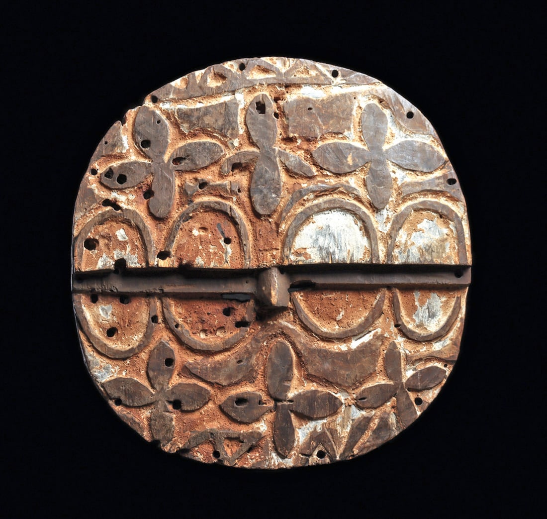 Teke Tsaye Mask: Carved for the Kidumu society, this disk-shaped mask features an upper facial plane slightly raised above the lower half, articulated by a stepped ridge and projecting nose set at eye level. The