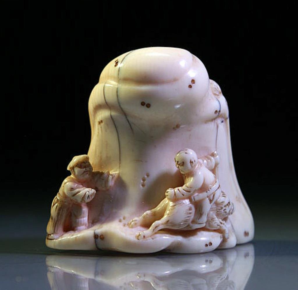 Japanese Ivory Netsuke: Figures on Rock, ex-Museum: Japan, Edo Period, Late 18th to Early 19th Century CE. One figure riding on a boar, the other with monkey climbing up the side. Collection Number on Base. 1-1/4"H x 1-1/2"W. Provenance: De-accessione