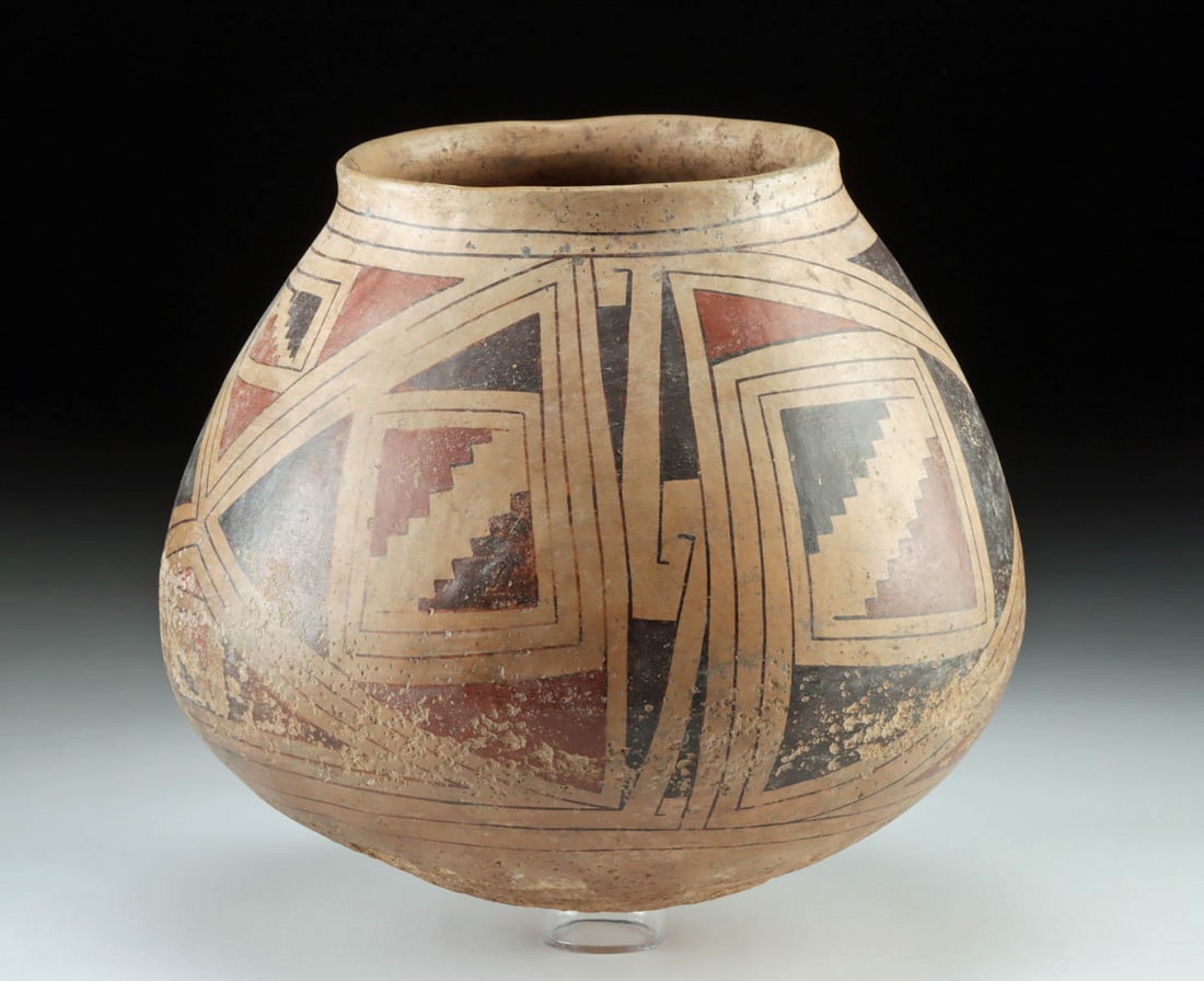Large Casas Grandes Polychrome Pottery Jar: Pre-Columbian, Northern Mexico, Chihuahua region, Casas Grandes culture, ca. 1100 to 1450 CE. A hand-built pottery jar of wide form bearing smooth, stone-burnished surfaces, a slightly flared rim, and