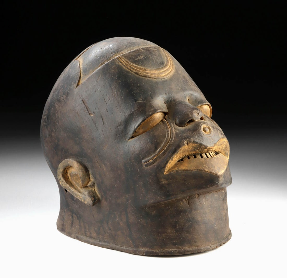 East African Makonde Wood Lipiko Helmet Mask: East Africa, southern Tanzania and northern Mozambique, Makonde peoples, ca. 20th century CE. A darkly commanding Makonde lipiko helmet mask, carved with a serene yet potent expression that seems to h