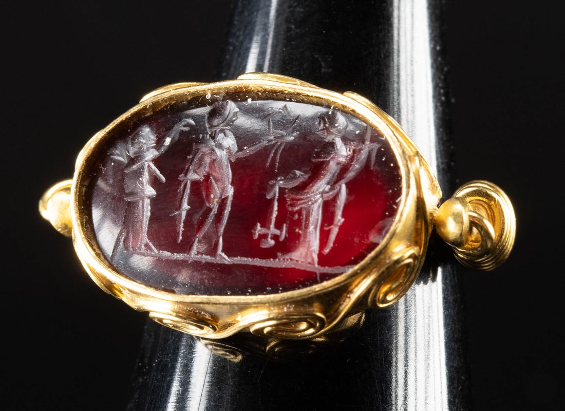 Roman Amethyst Intaglio w/ Gods in Gold Ring: Roman, Imperial period, ca. 1st to 3rd century CE; Europe, ca. 20th century CE. A Roman amethyst intaglio depicting the gods Mars, Fortuna, and Victory is set in a modern high-karat gold swivel ring,