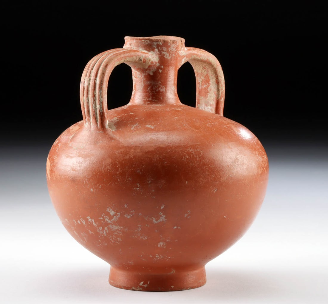 Roman Redware Spouted Vessel, Striated Handles: Roman, Imperial Period, ca. 1st to 3rd century CE. A wheel-thrown redware pottery vessel with an apple-shaped body and a pair of striated handles arching away from a central spout, all atop a squat