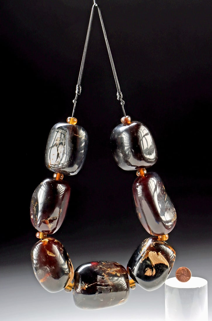 Giant Indonesian Polished Amber Bead Necklace: Southeast Asia, Indonesia, Sumatra, ca. 20th century CE. An oversized strand of Sumatran amber beads (weighing a hefty 1.2 pounds), carved into bold, rounded baubles with smaller spacer beads and stru