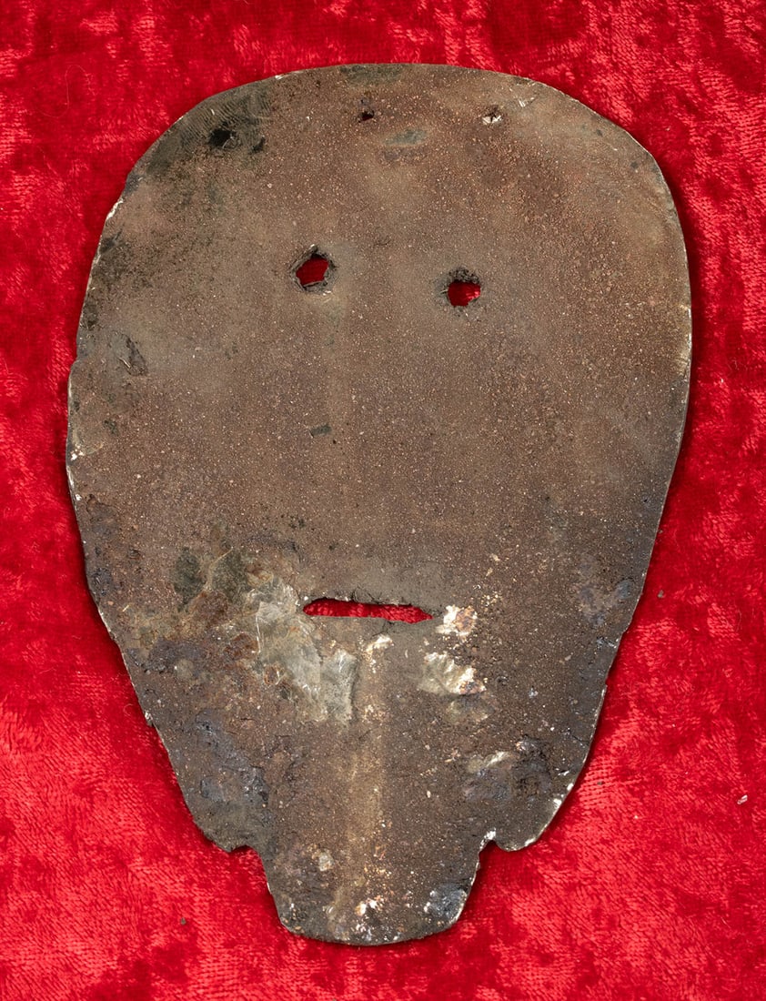 Exceptionally Rare Ancient Hopewell Mica Sheet Mask: Native American, Midwestern United States, Ohio, Ross County, Hopewell culture, ca. 200 BCE to 500 CE. An exceptionally rare mica sheet carved into a stylized human face mask. The form is flat and thi