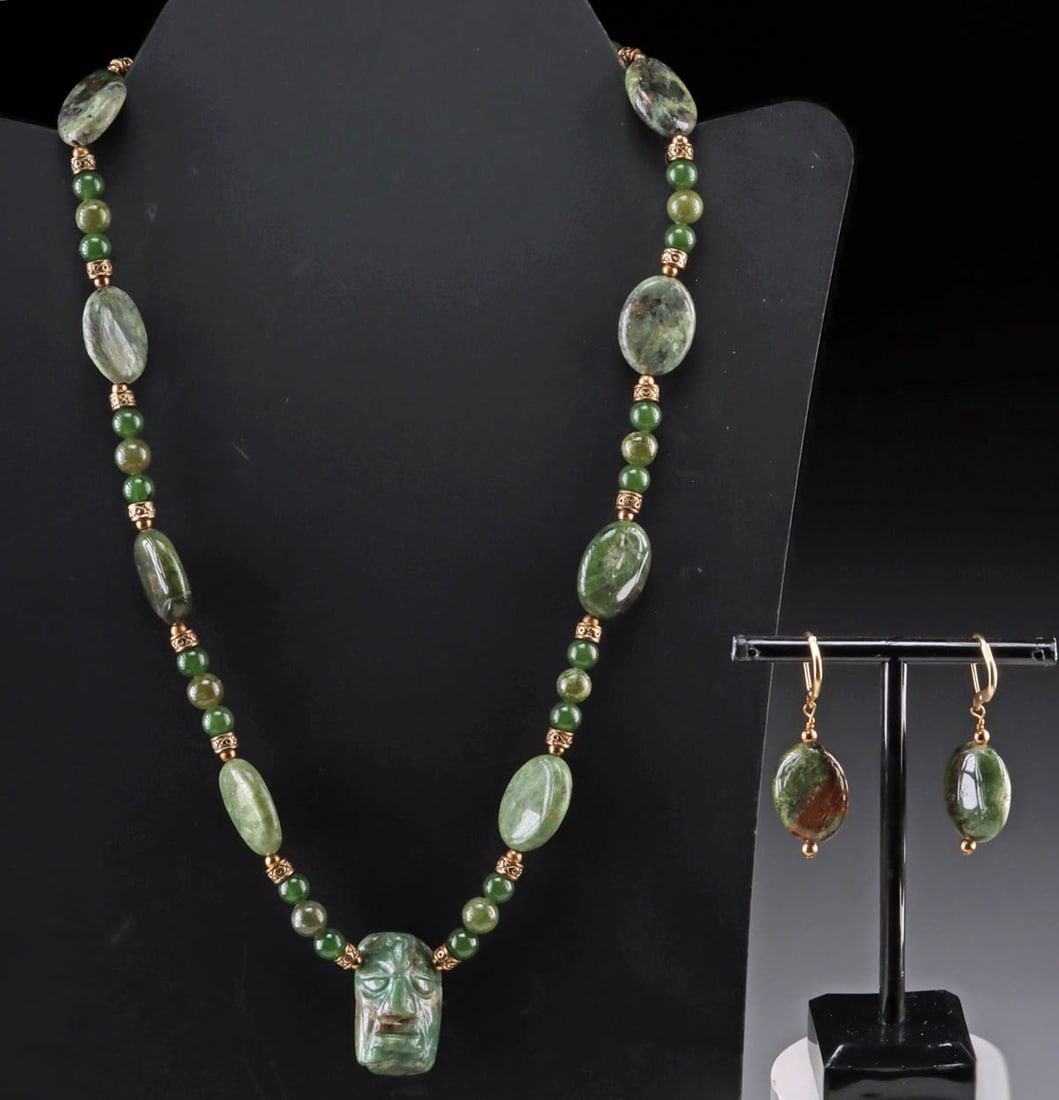 Maya Imperial Face Bead Necklace & Earring Ensemble: Pre-Columbian (center pendant bead), Maya, ca. 500 to 900 CE. Wonderful carved hard greenstone bead of Maya origins, strung together with similar colored greenstone beads and discs. Beads are interspe