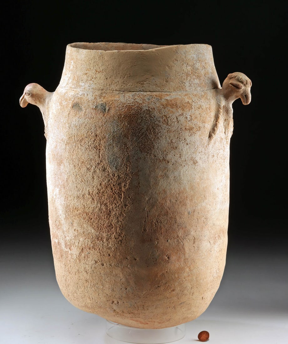 Large Colombian Moskito Funerary Urn with Bird Handles: Pre-Columbian, Colombia, Lower Magdalena River Region, Moskito culture, ca. 1000 to 1500 CE. A large funerary urn with an ovoid body tapering to a rounded base and a wide neck, fitted at the
