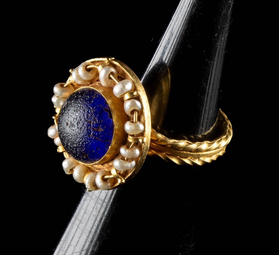 Georgian to Victorian Gold Ring w/ Blue Glass & Pearls: Europe, Late Georgian to Early Victorian period, ca. 1790 to 1840 CE. A quietly theatrical ring, this piece balances intimacy and ornament with the easy confidence of late Georgian taste moving toward