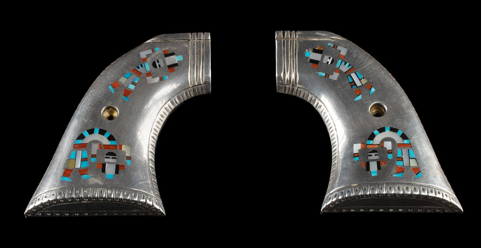 Zuni Sterling Silver Kachina Inlay Colt Revolver Grips: Native American, Southwestern United States, Zuni Pueblo, ca. mid to late 20th century CE. A matched pair of revolver grips cast in sterling silver, each panel shaped to the classic curved profile and
