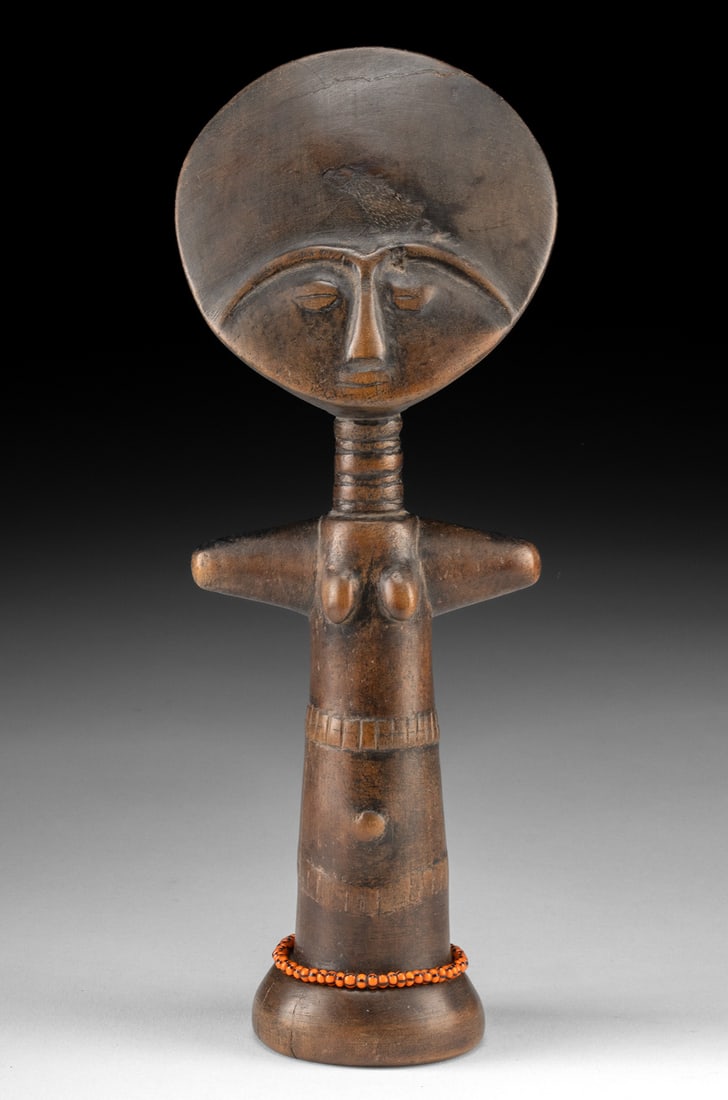 African Ashanti Wood Akua'ba Fertility Doll Figure: West Africa, Ghana, Asante / Ashanti people, ca. 19th to early 20th century CE. A hand-carved wooden fertility figure known as an Akua'ba doll. The sculpture presents the classic stylized form with a