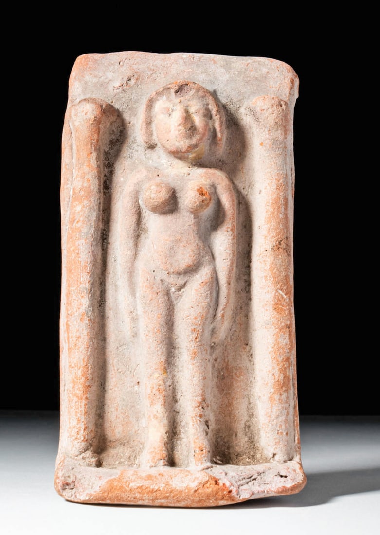 Phoenician Terracotta Plaque, Tanit-Type: Phoenician (Levant or Punic West), ca. 600 to 400 BCE. A rectangular terracotta plaque with a recessed central field framed by two rounded columns. Within the niche stands a stylised nude female figur