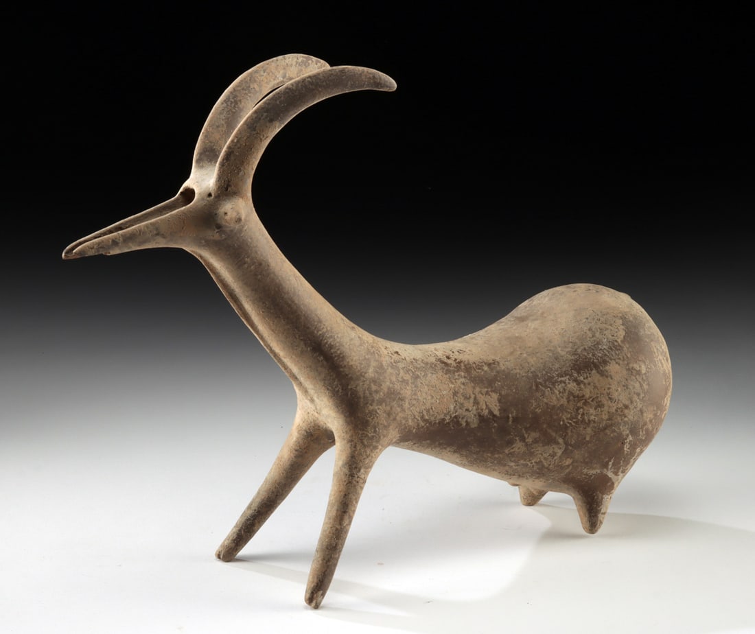 Amlash Zoomorphic Rhyton with Sweeping Ibex Horns: Ancient Near East, northwestern Persia, Amlash, ca. 10th to 9th century BCE. A rare Amlash pottery rhyton in the form of an ibex, modeled with a slender neck, angular body, and high-arching horns