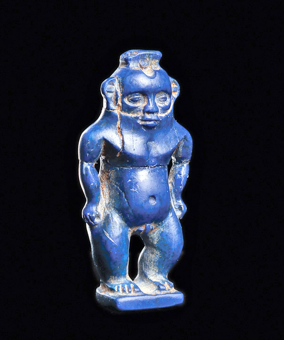 Egyptian Lapis Lazuli Bes: Carved brilliant cobalt blue lapis lazuli stone standing figure of the god Bes, god of children and games. Well carved and detailed facial features and anatomy, having a rounded stomach and buttocks.